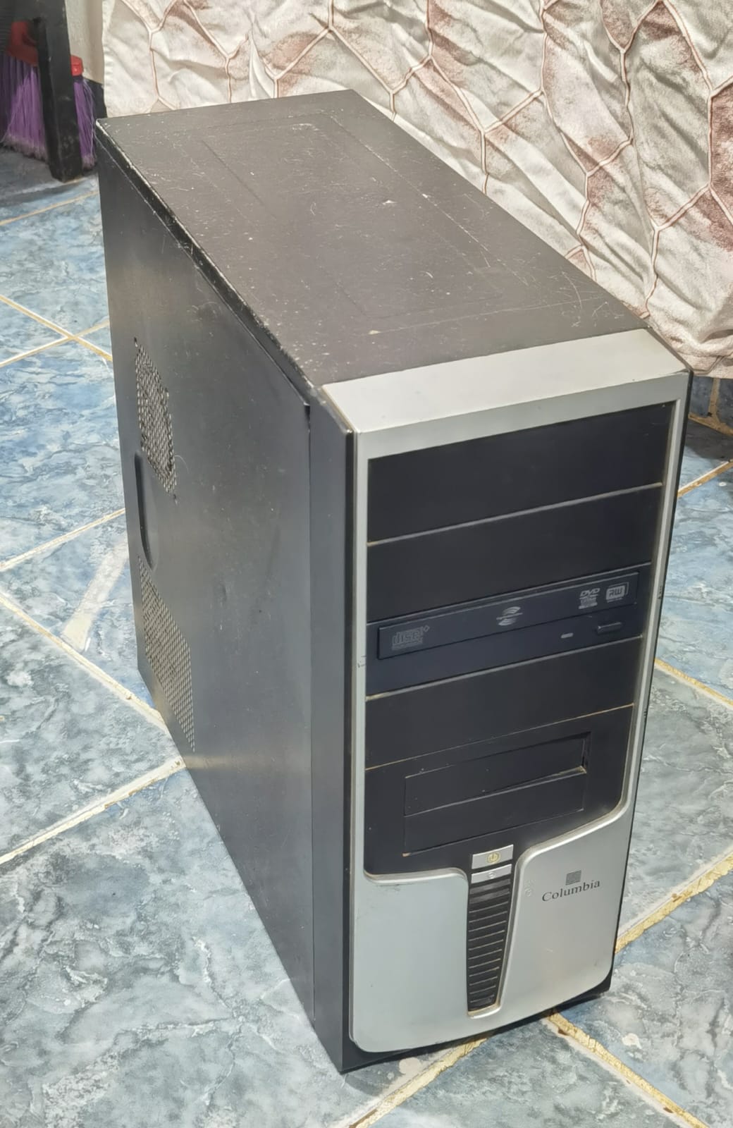 a black tower computer with a gray front plate with a disc drive visible and a columbia branding